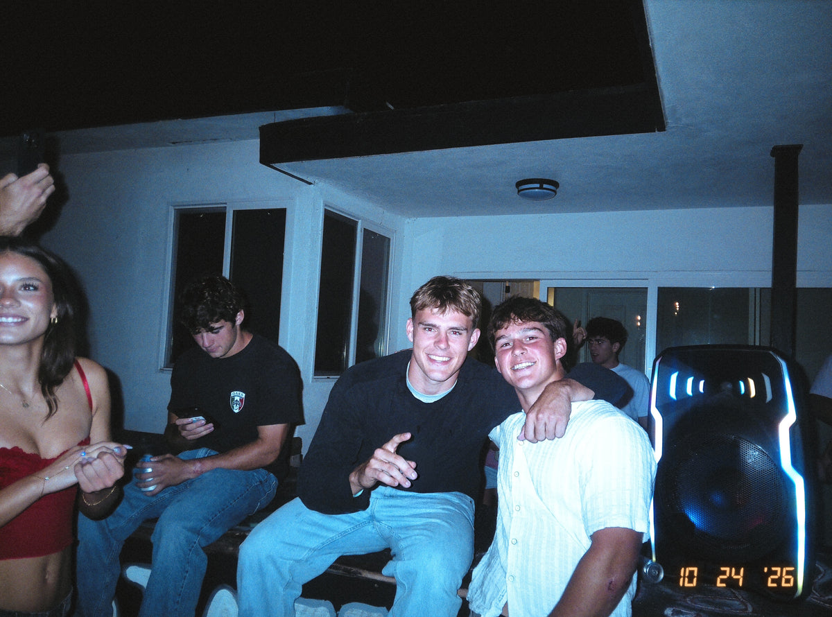 Three friends together at a party, photographed on DigiFilm.
