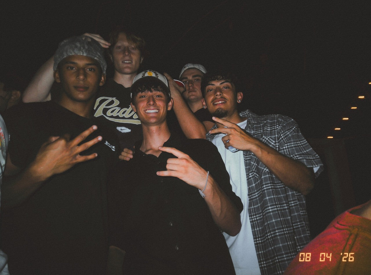 A group of friends posing together at night in a direct-flash DigiFilm photo.
